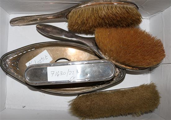 4 silver brushes and an inkstand base